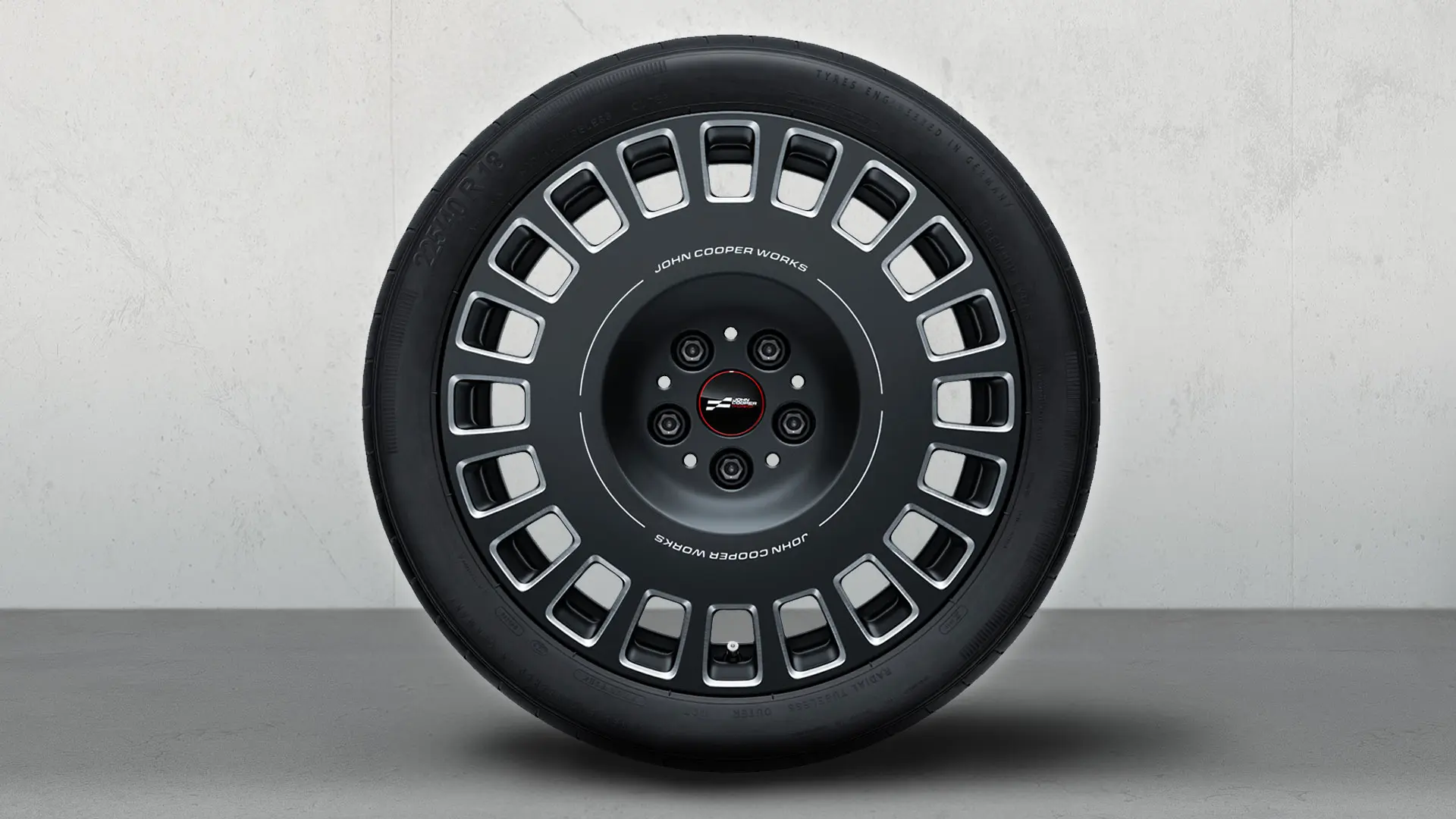 Колесо MINI JCW 18" Rallye Spoke 992 із логотипом JCW, двоколірним дизайном у кольорі Frozen Midnight Grey та глянцевим фрезерованим покриттям.